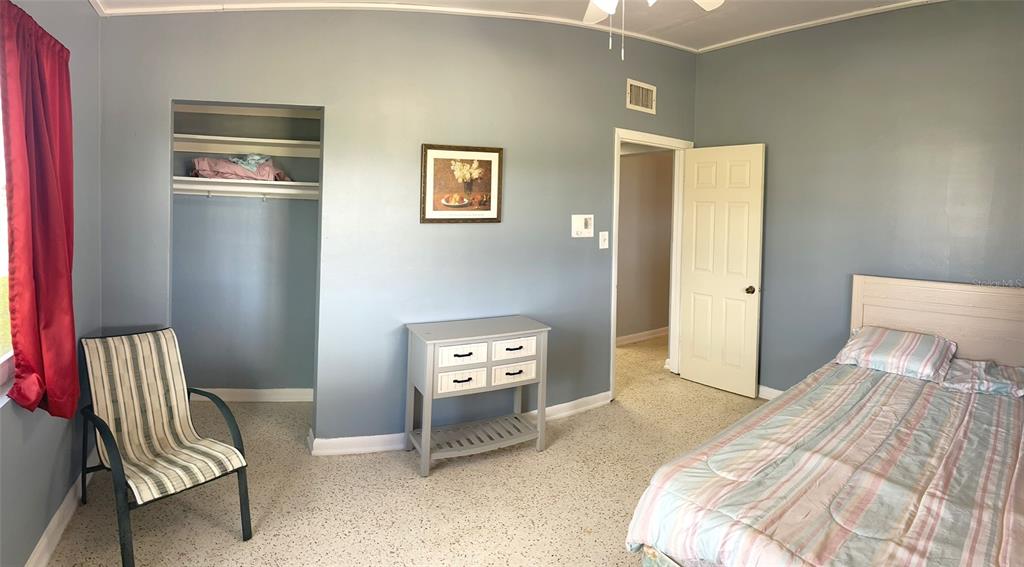 554 Lindley Terrace Port Charlotte, FL 33952 - Photo 30 of 57 a bedroom with a bed and a chair