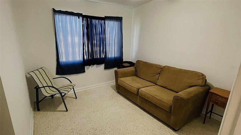 554 Lindley Terrace Port Charlotte, FL 33952 - Photo 32 of 57 a living room with furniture and a rug