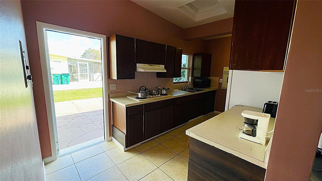 554 Lindley Terrace Port Charlotte, FL 33952 - Photo 35 of 57 a kitchen with a sink a stove and a refrigerator