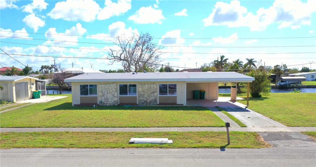 554 Lindley Terrace Port Charlotte, FL 33952 - Photo 39 of 57 a view of a house with a big yard plants and large trees