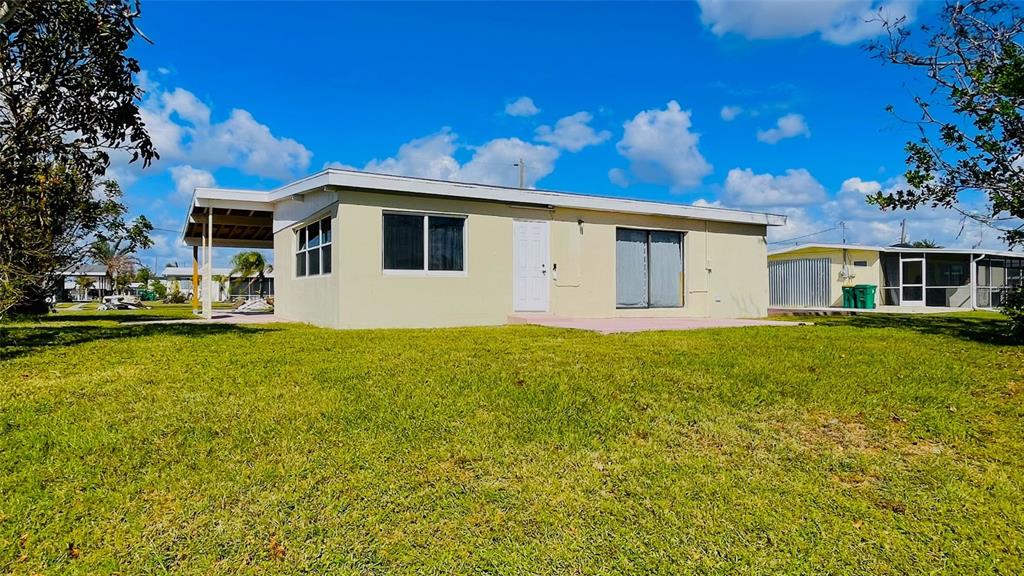 554 Lindley Terrace Port Charlotte, FL 33952 - Photo 50 of 57 a front view of a house with garden