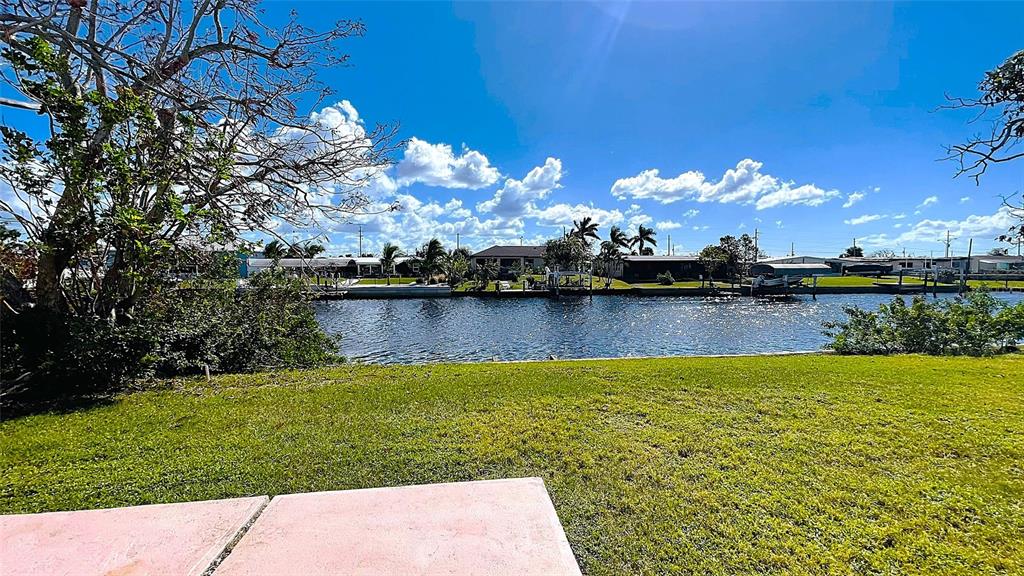 554 Lindley Terrace Port Charlotte, FL 33952 - Photo 52 of 57 a view of a lake with a big yard