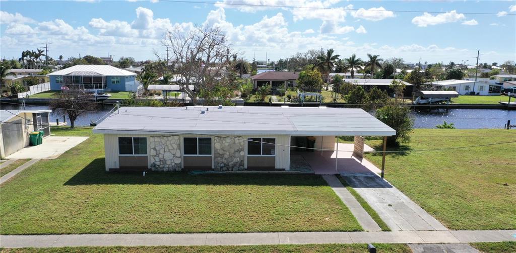 554 Lindley Terrace Port Charlotte, FL 33952 - Photo 6 of 57 a aerial view of a house with swimming pool and furniture