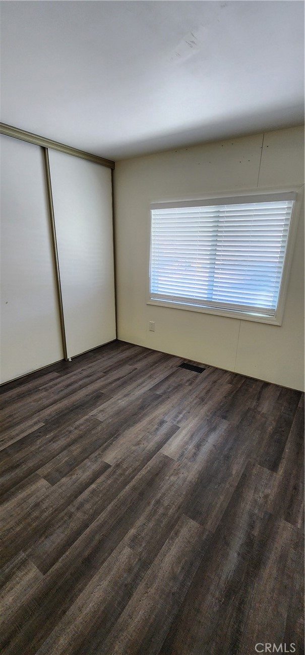 3589 West Wells Road, Unit 99 Blythe, CA 92225 - Photo 11 of 26 a view of an empty room with wooden floor and a window