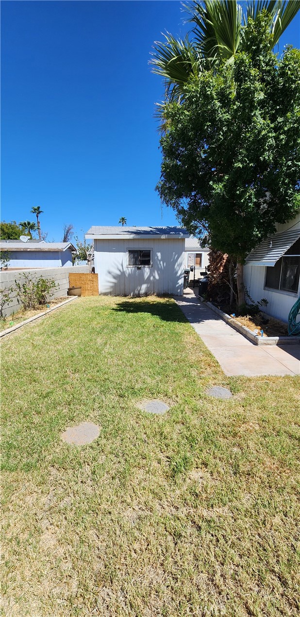 3589 West Wells Road, Unit 99 Blythe, CA 92225 - Photo 15 of 26 a swimming pool with outdoor seating and yard