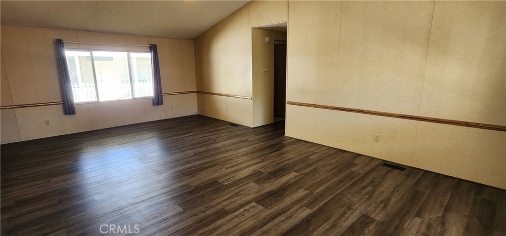 3589 West Wells Road, Unit 99 Blythe, CA 92225 - Photo 3 of 26 a view of empty room with wooden floor and window