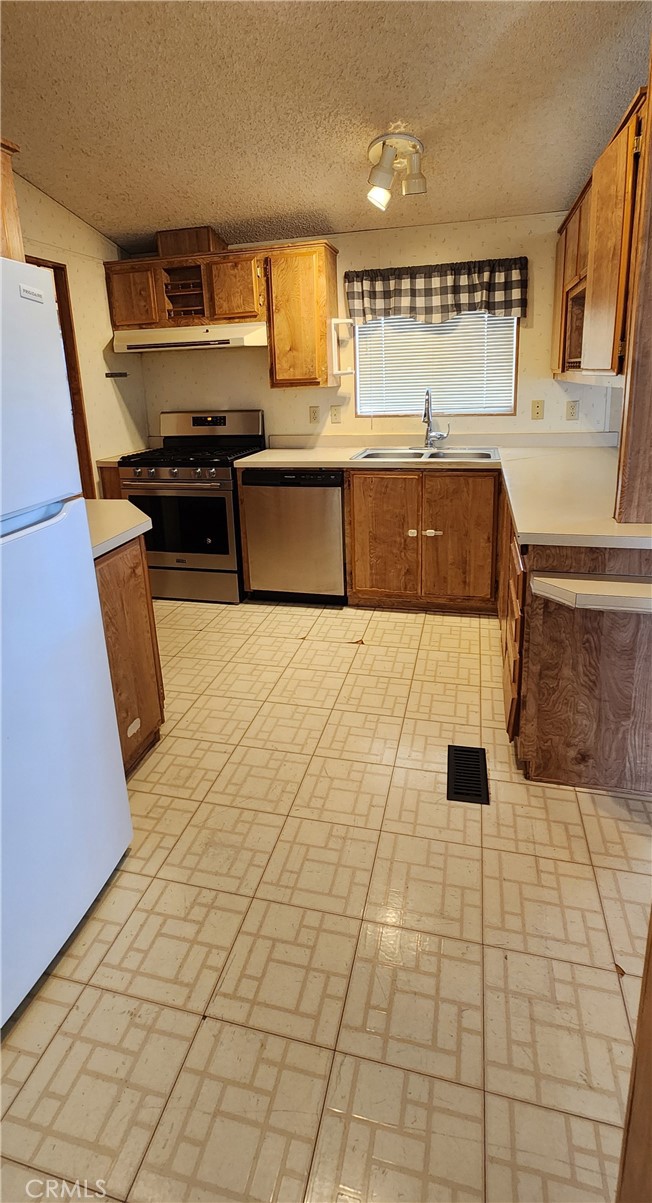 3589 West Wells Road, Unit 99 Blythe, CA 92225 - Photo 5 of 26 a kitchen with stainless steel appliances a sink and a counter top space