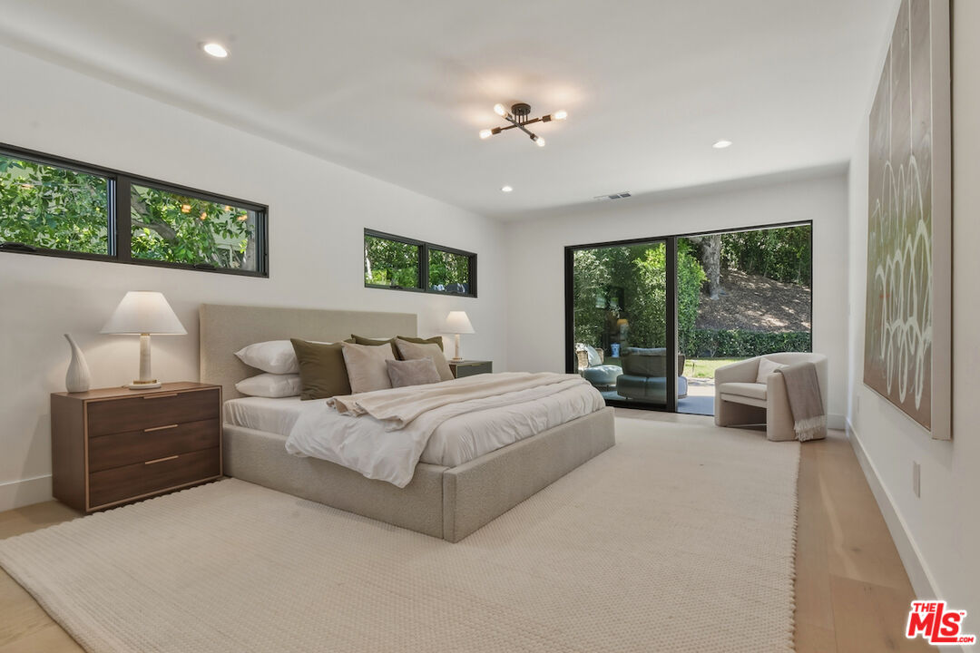 3721 Woodcliff Road Sherman Oaks, CA 91403 - Photo 22 of 35 a spacious bedroom with a large bed and a large window
