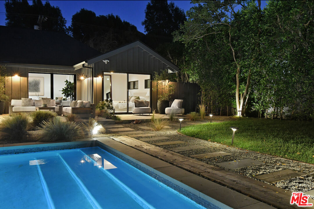 3721 Woodcliff Road Sherman Oaks, CA 91403 - Photo 30 of 35 a view of a patio with table and chairs a fire pit and large trees