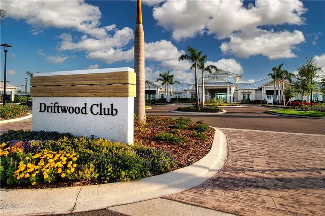 a view of a patio with table and chairs potted plants and palm tree