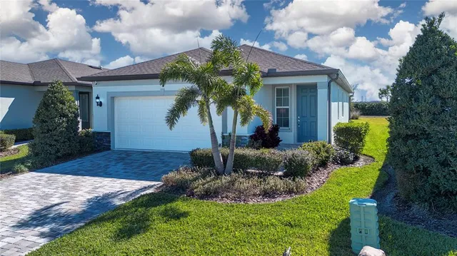 an aerial view of a house with garden space and street view