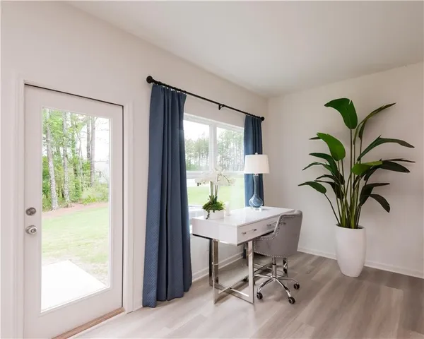 a living room with furniture and wooden floor