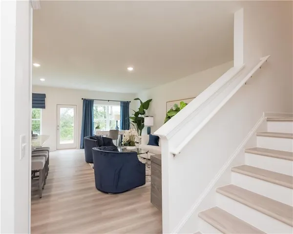 a living room with furniture and large windows