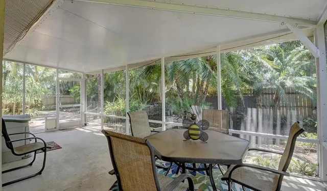 a room with pool table and chairs
