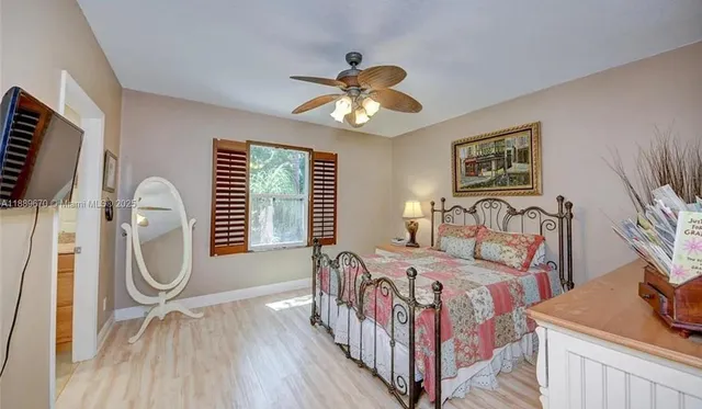 a bathroom with a granite countertop sink a large mirror and a shower
