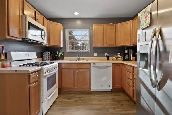 a kitchen with stainless steel appliances granite countertop a stove a sink and a microwave