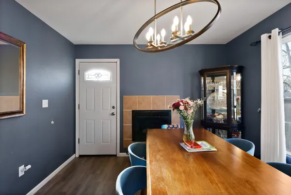 a view of a dining room with furniture wooden floor and a chandelier