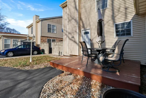 a view of a house with backyard and sitting area