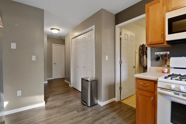 a view of kitchen with stainless steel appliances cabinets and wooden floor