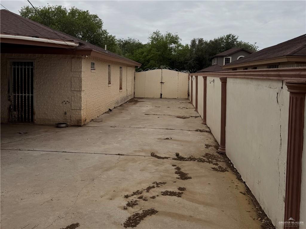 937 Whitewing Street Roma, TX 78584 - Photo 11 of 14 View of side of home with a gate and brick siding