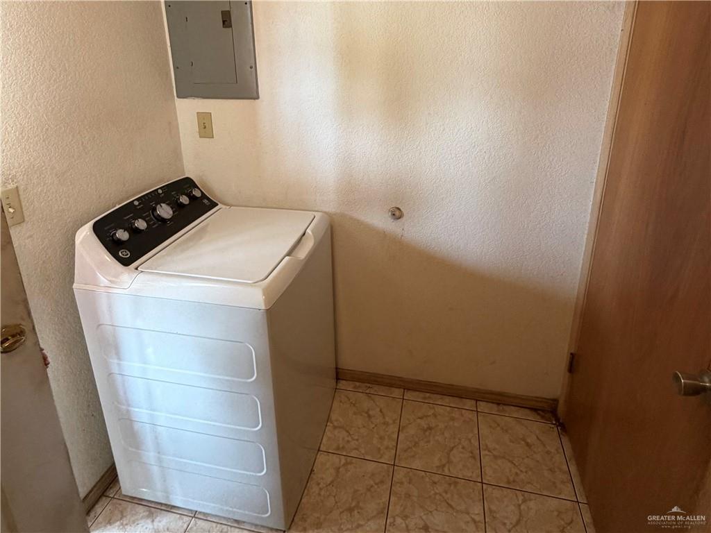 937 Whitewing Street Roma, TX 78584 - Photo 9 of 14 Laundry area with washer / dryer, a textured wall, and electric panel