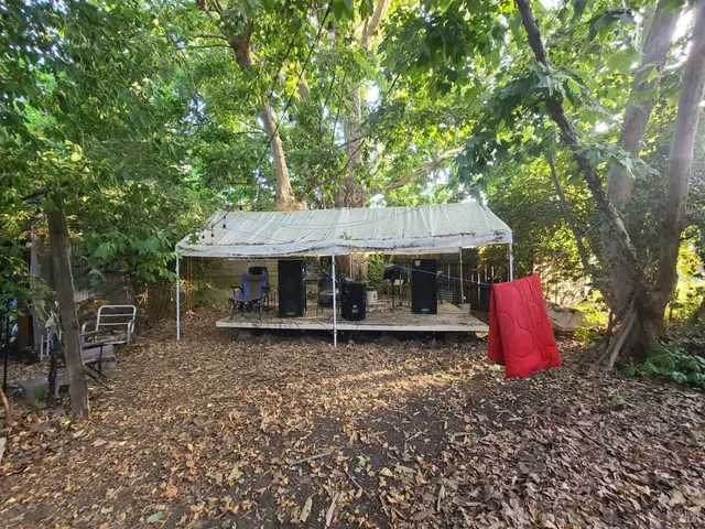 an aerial view of a house with backyard