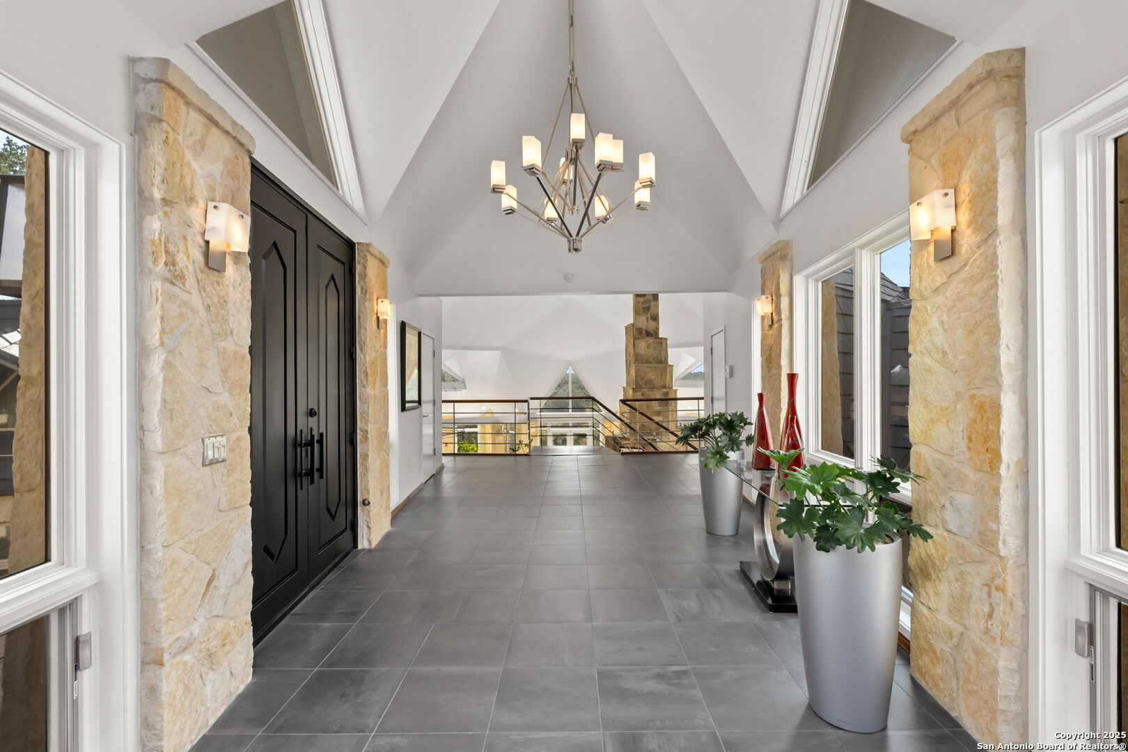 117 Clear Spring Drive Boerne, TX 78006 - Photo 20 of 54 a view of a hallway with a flower pot and a bookshelf