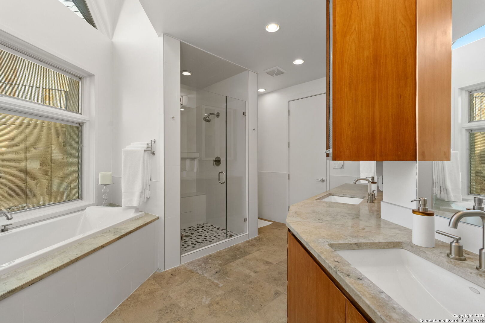 117 Clear Spring Drive Boerne, TX 78006 - Photo 34 of 54 a bathroom with a granite countertop sink mirror and a bathtub
