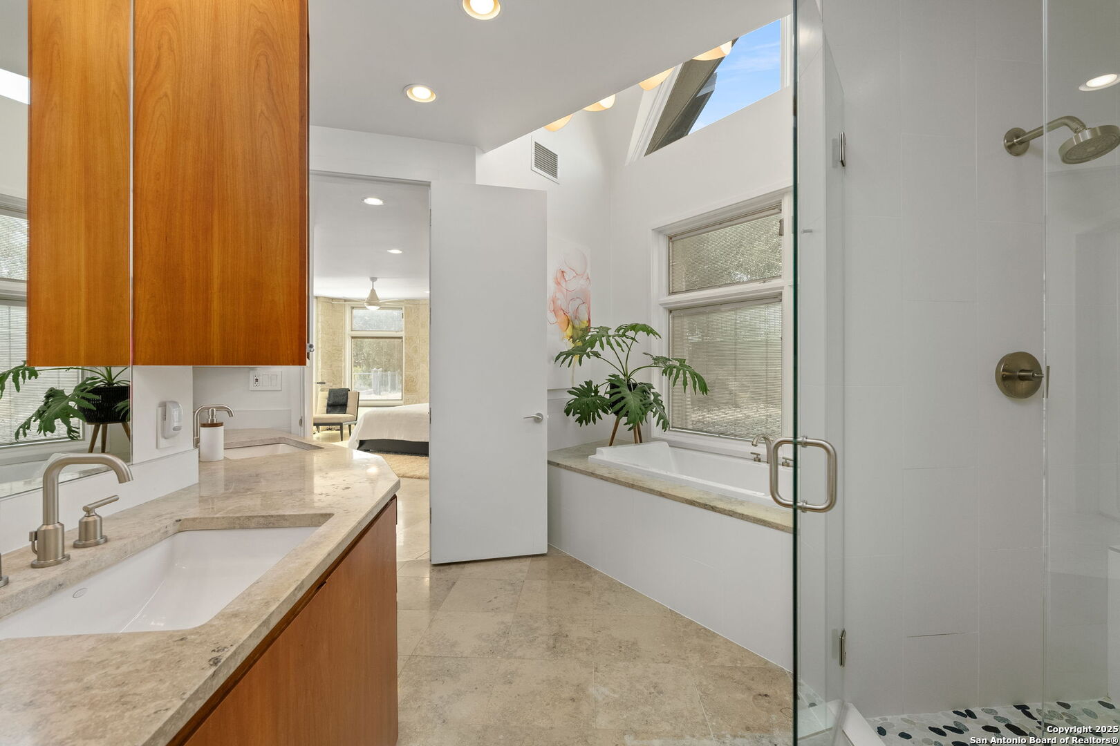 117 Clear Spring Drive Boerne, TX 78006 - Photo 37 of 54 a bathroom with a granite countertop sink a mirror and a shower