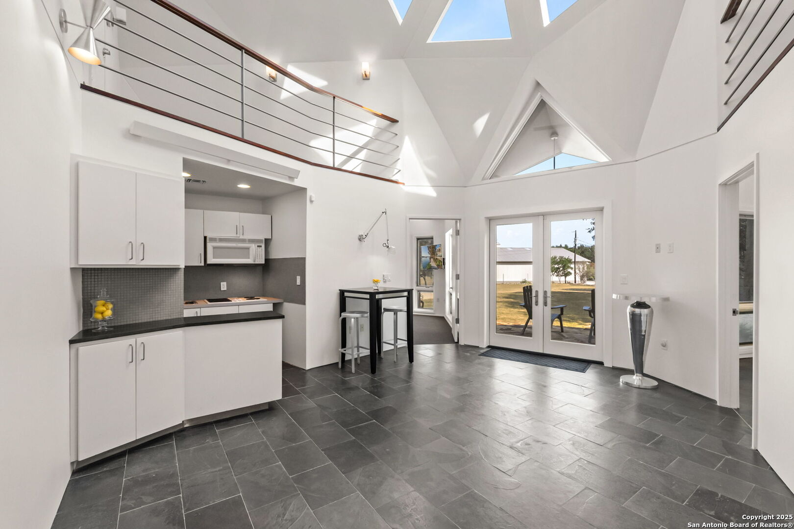 117 Clear Spring Drive Boerne, TX 78006 - Photo 42 of 54 a kitchen with stainless steel appliances kitchen island granite countertop a refrigerator a sink a stove and white cabinets with wooden floor