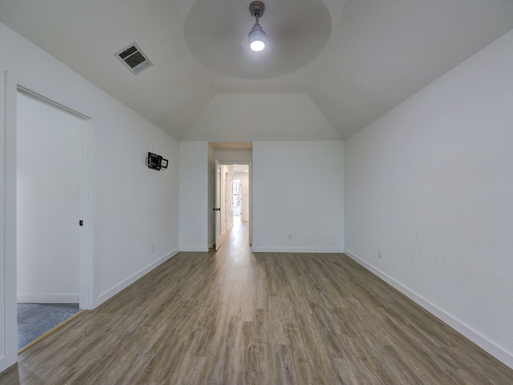 5842 Secrest Drive Austin, TX 78759 - Photo 20 of 40 An inviting room awaits with resilient flooring and soaring vaulted ceilings.