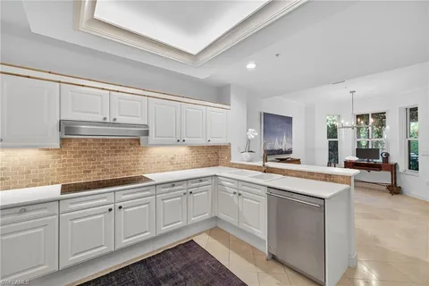 a kitchen with sink cabinets and chair