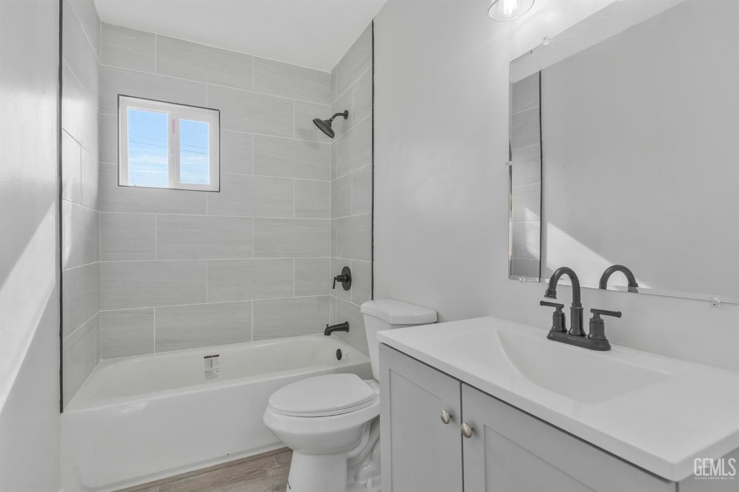 Undisclosed Address Bakersfield, CA 93304 - Photo 12 of 29 a bathroom with a sink mirror toilet and bathtub