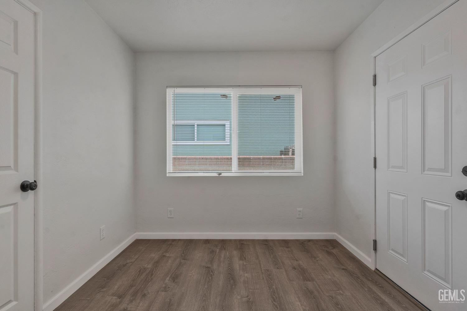 Undisclosed Address Bakersfield, CA 93304 - Photo 13 of 29 a view of an empty room with wooden floor and a window