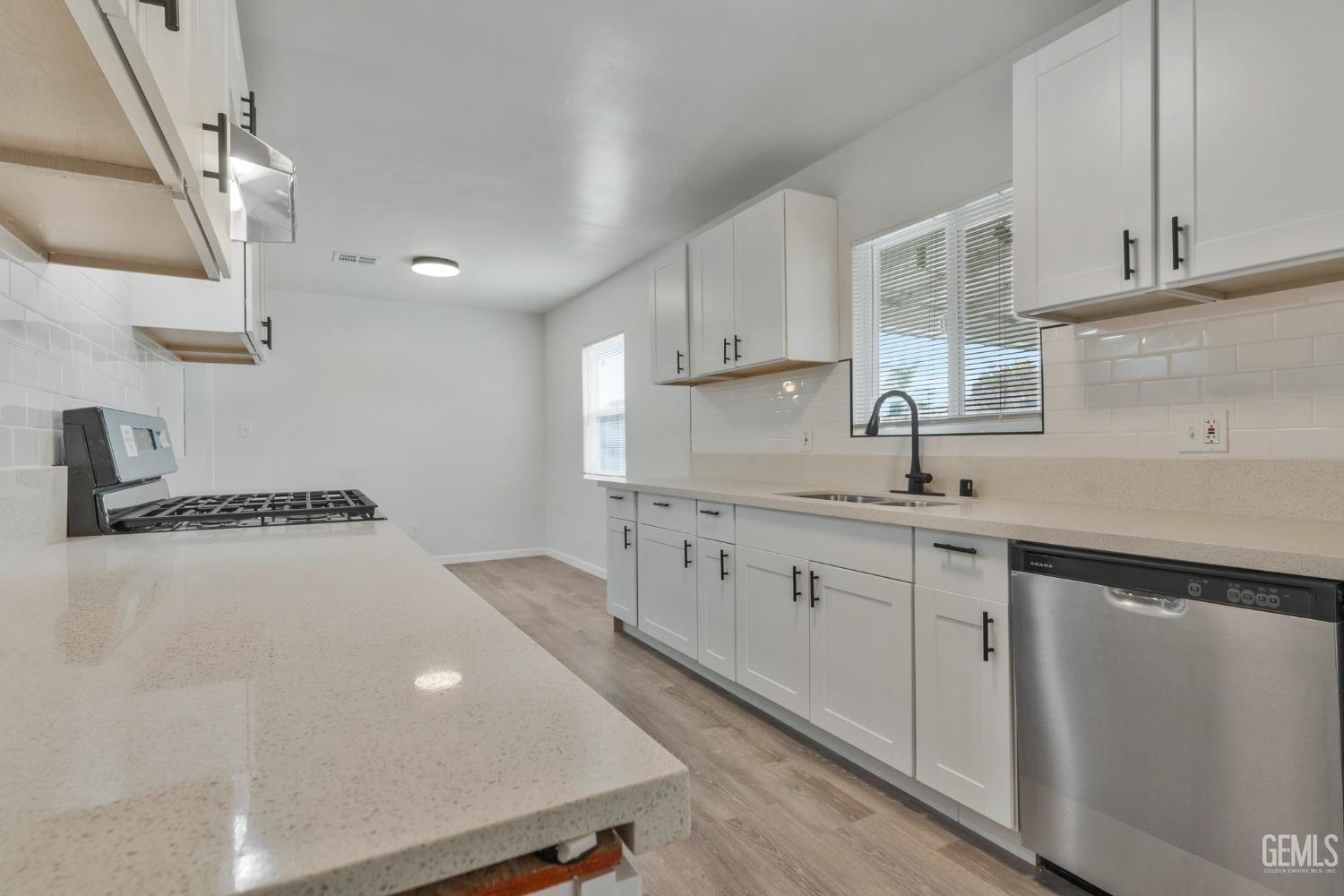 Undisclosed Address Bakersfield, CA 93304 - Photo 23 of 29 a kitchen with white cabinets and a sink