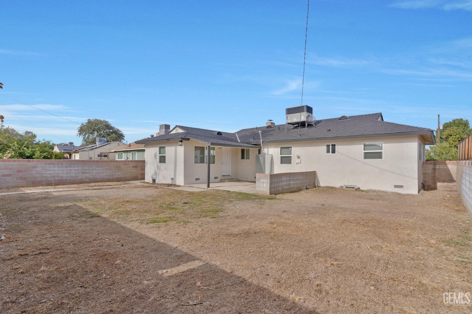 Undisclosed Address Bakersfield, CA 93304 - Photo 28 of 29 a front view of a house with a yard and garage