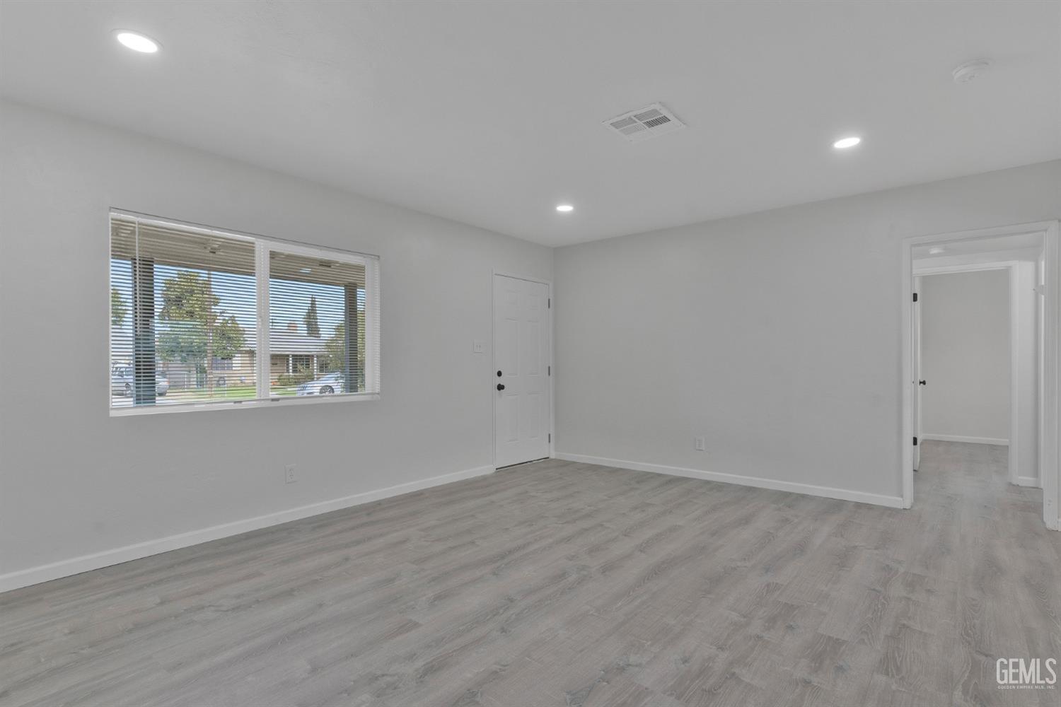 Undisclosed Address Bakersfield, CA 93304 - Photo 5 of 29 an empty room with wooden floor and window