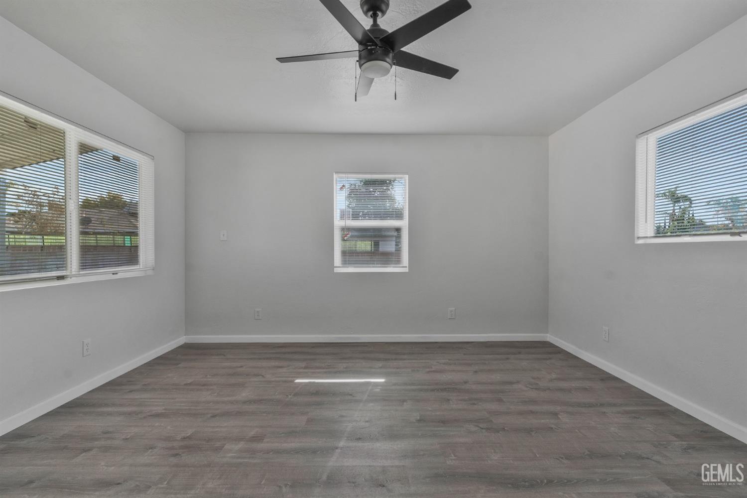 Undisclosed Address Bakersfield, CA 93304 - Photo 10 of 29 a view of an empty room with a window and wooden floor