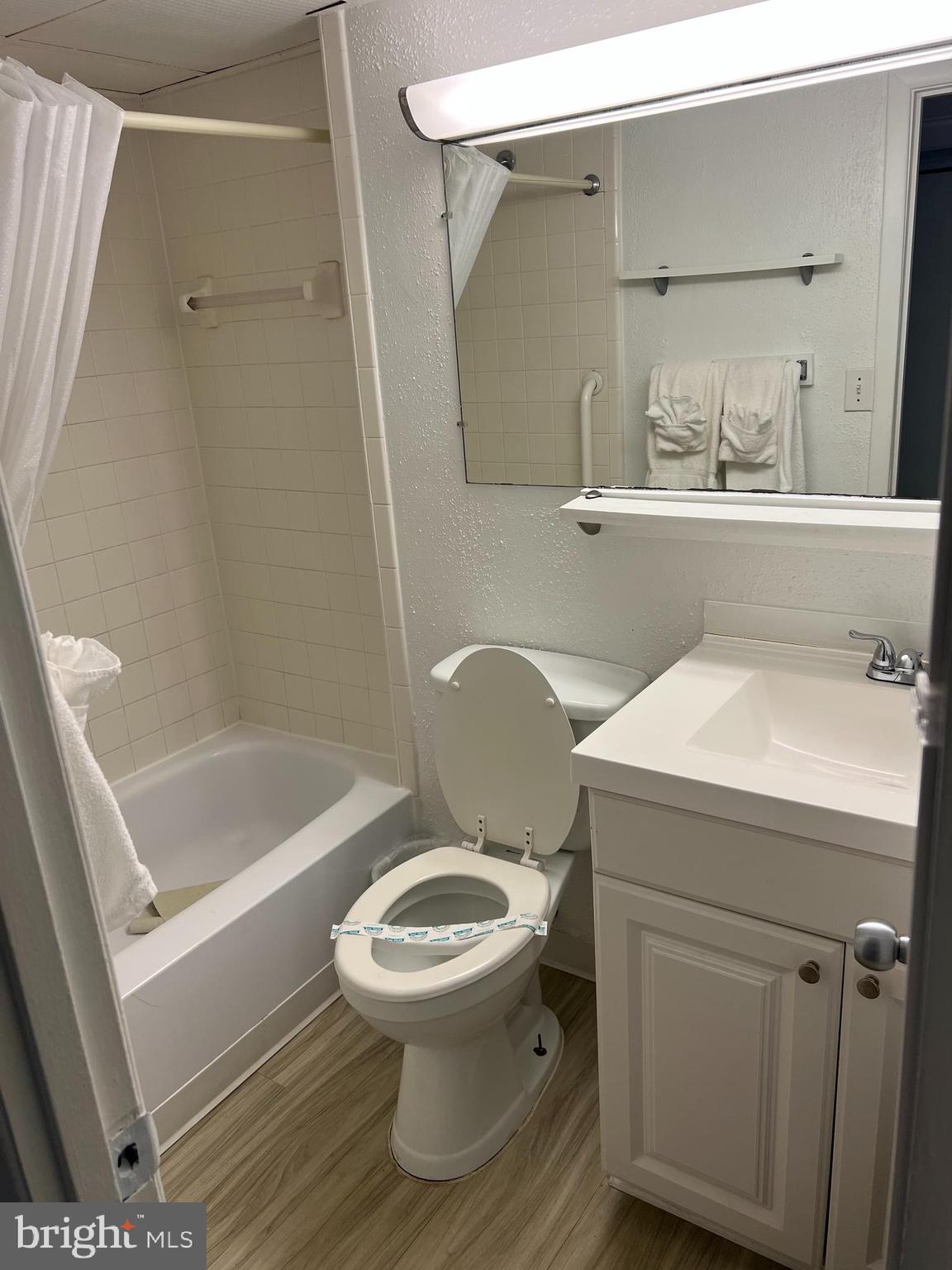 107 North Atlantic Avenue, Unit 201 Ocean City, MD 21842 - Photo 7 of 25 a bathroom with a sink a toilet and shower