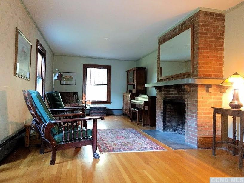 20 Hunt Road Hillsdale, NY 12529 - Photo 5 of 10 a living room with furniture a fireplace and a flat screen tv
