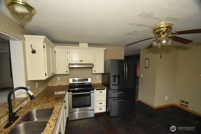 a kitchen with a refrigerator and a sink