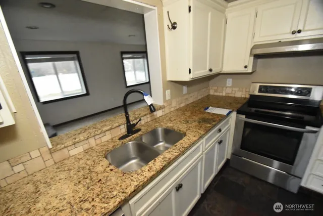 a kitchen with a stove and a sink