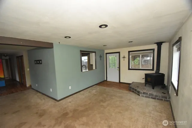 an empty room with windows and closet