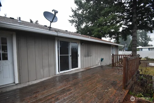 a black and white house with trees in the background