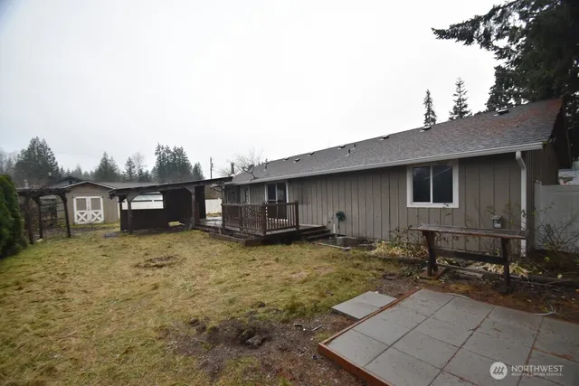 a backyard of a house with yard and barbeque oven