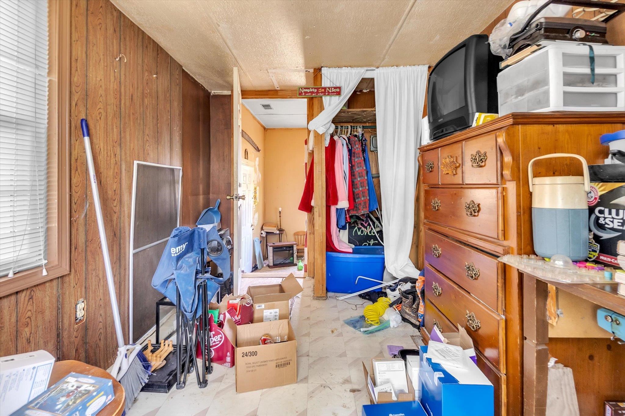 216 Burch Road Dyersburg, TN 38024 - Photo 5 of 25 a view of walk in closet with clothes and shoes