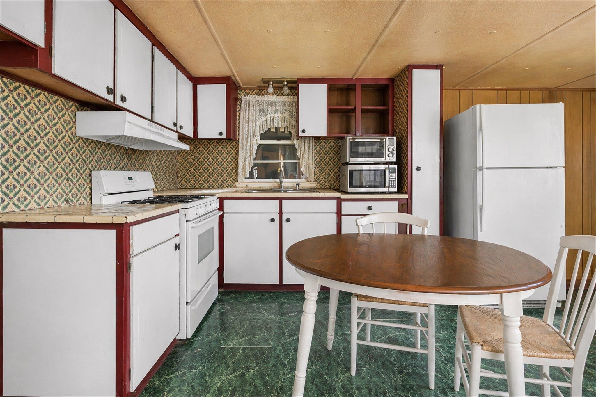 216 Burch Road Dyersburg, TN 38024 - Photo 10 of 25 a kitchen with stainless steel appliances granite countertop a sink a stove and a refrigerator