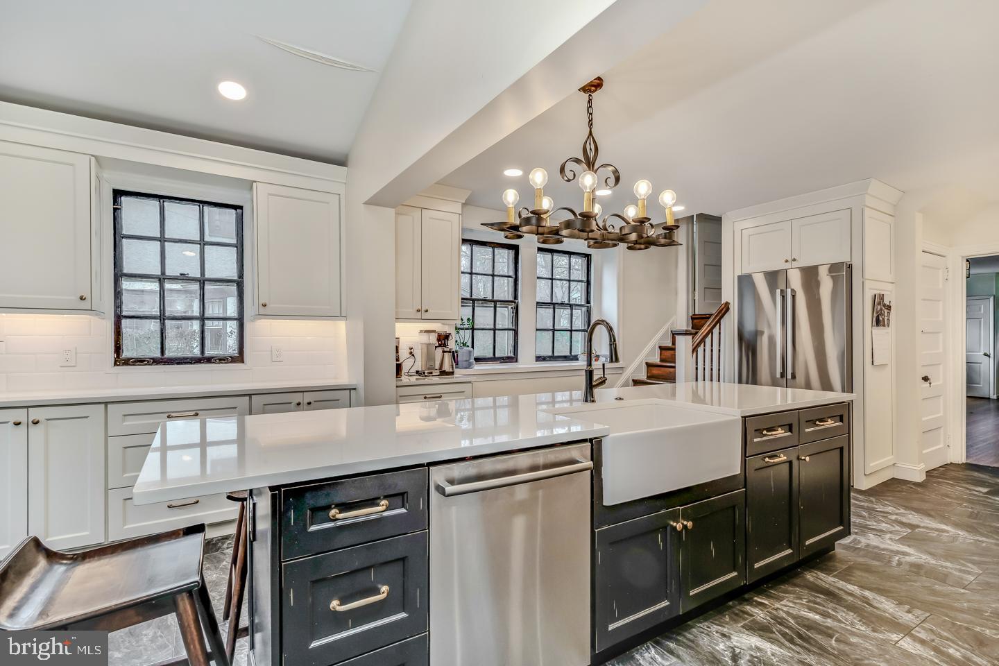 114 Llanfair Road Ardmore, PA 19003 - Photo 29 of 80 a kitchen with kitchen island granite countertop a sink cabinets and stainless steel appliances