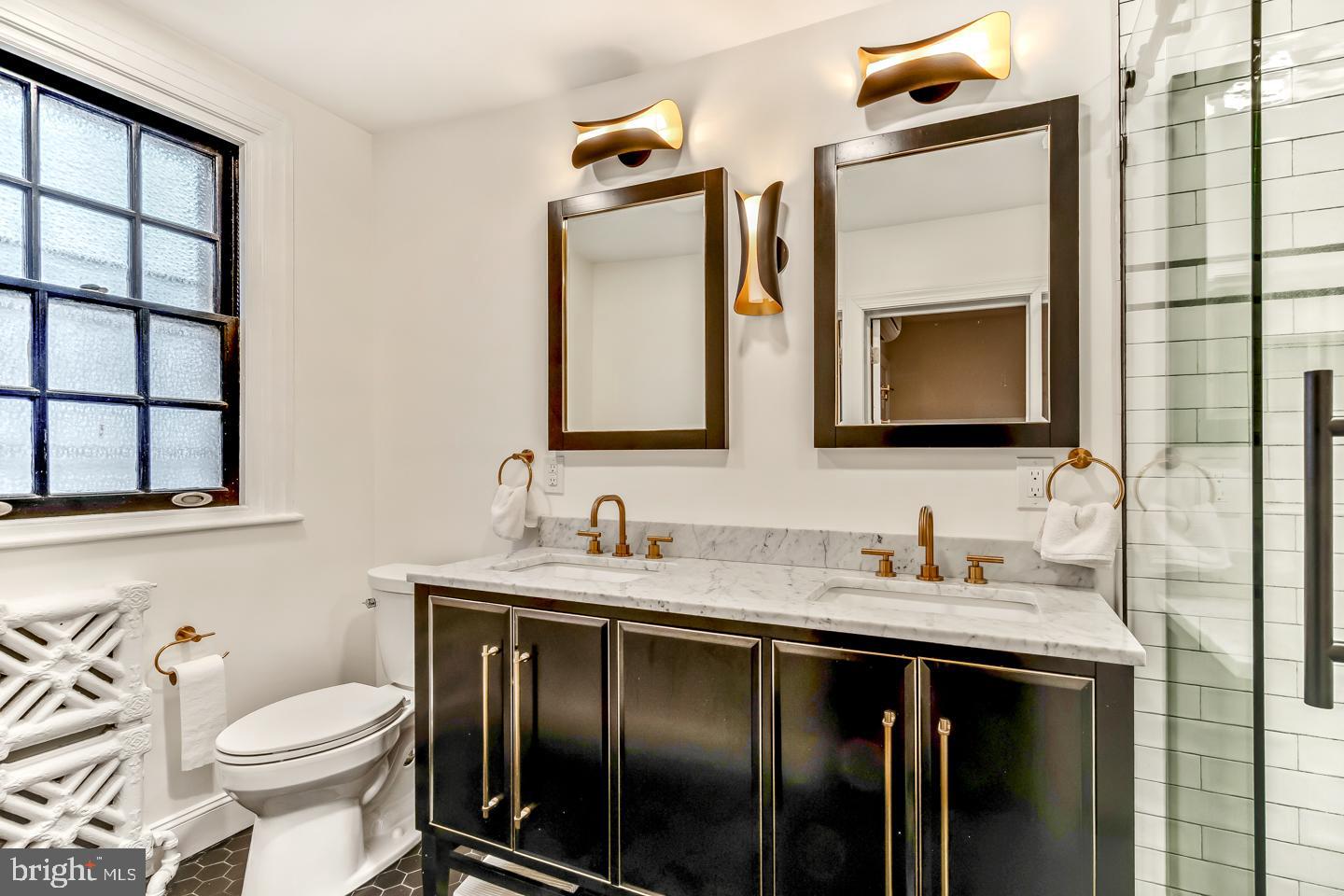 114 Llanfair Road Ardmore, PA 19003 - Photo 39 of 80 a bathroom with a toilet sink and mirror