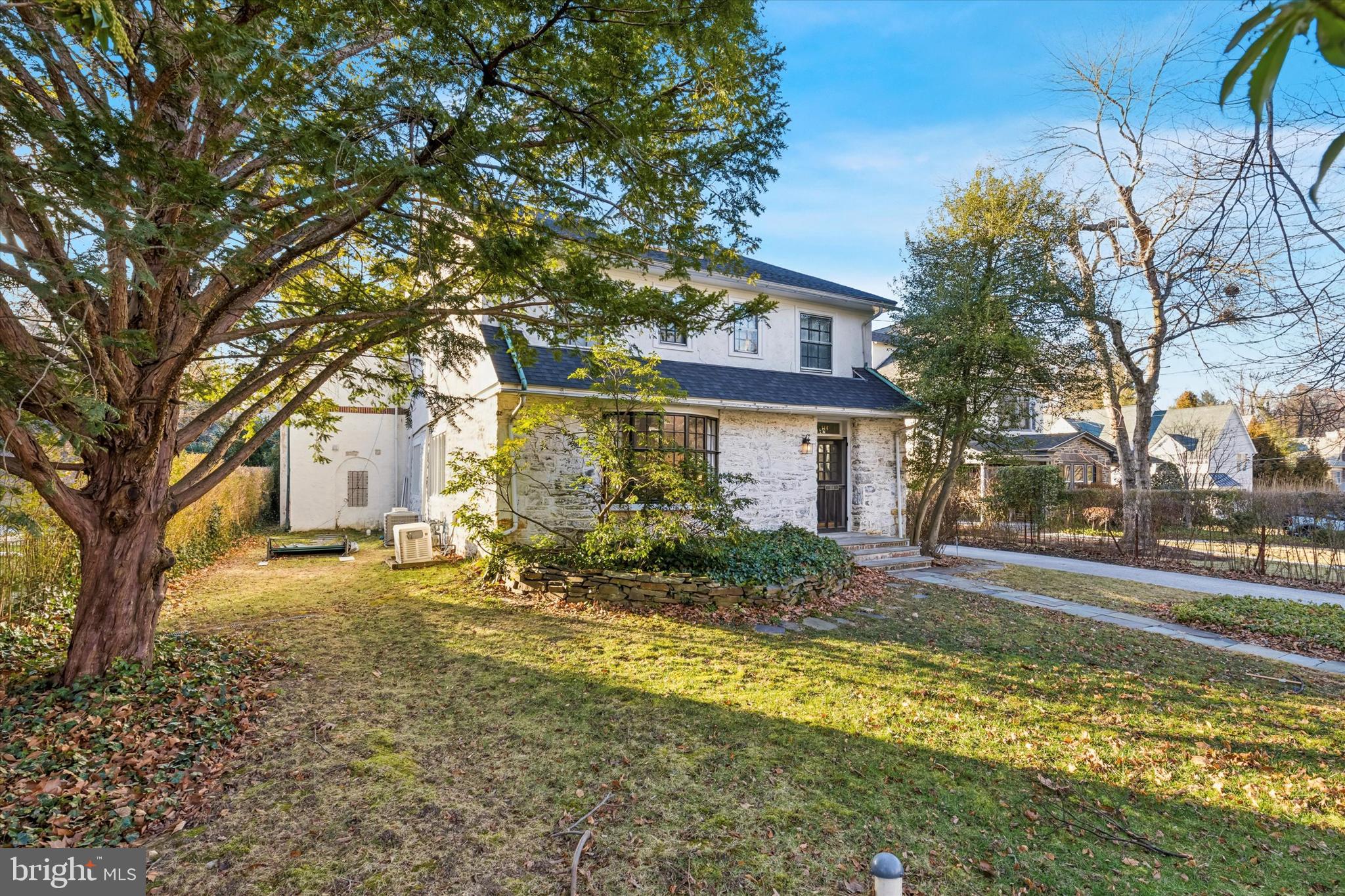 114 Llanfair Road Ardmore, PA 19003 - Photo 5 of 80 a view of a yard in front of a brick house with large tree